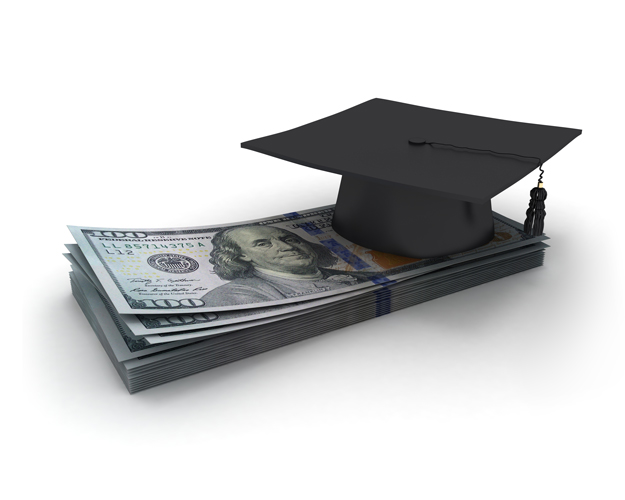 A stack of one hundred dollar bills with a graduation cap on top if it.